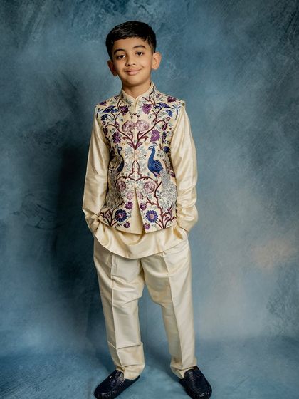 A full-length shot of our peacock embroidered Bundi set. The off-white silk and detailed threadwork create a look of understated luxury, perfect for making a sophisticated statement.