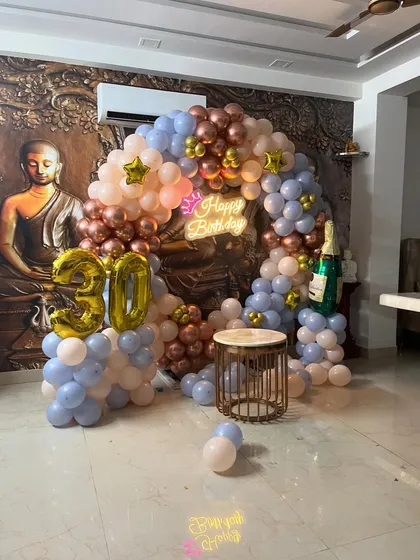 A full view of the elegant 30th birthday party decor, set against a decorative wall.
