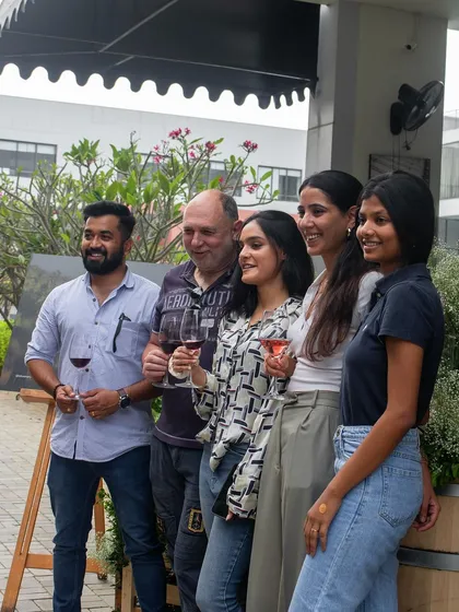 A group of guests posing for a photo at our Wine Picnic.