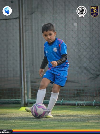 A young player in Pune demonstrates excellent ball control and awareness. This is the foundation of a great footballer.