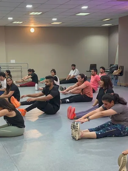 A seated forward bend stretch during our cool-down. This is an important part of the class to help your body recover and increase your range of motion over time.