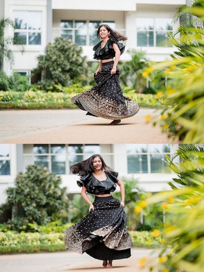A young woman twirls in her beautiful lehenga, her hair flying, during an outdoor family photoshoot.