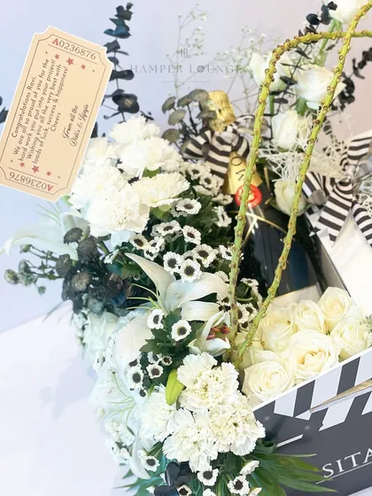 A detail shot showing the personalized gift tag and the bottle of Moët & Chandon included in the film launch hamper. Every element is carefully chosen to reflect a standard of luxury and thoughtful curation.