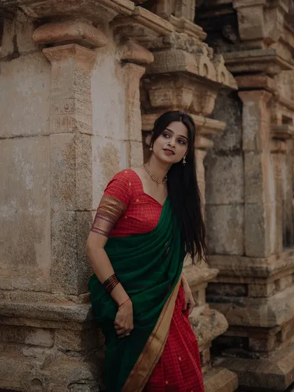 A portrait of a dancer in traditional attire, set against the beautiful architecture of a temple. The composition highlights both the dancer's grace and the historic setting.