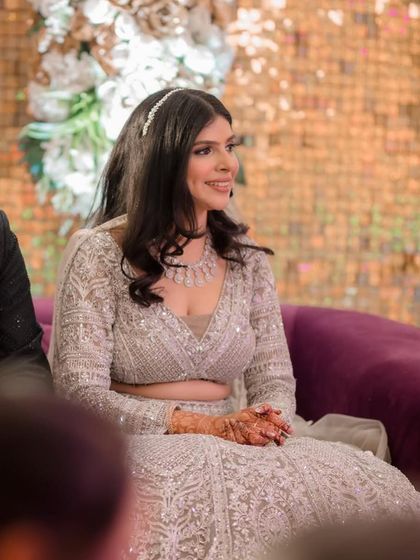 My bride Vaidehi at her Sangeet, looking elegant in a silver-grey lehenga. The makeup is soft and romantic, with open hair and a delicate headband.