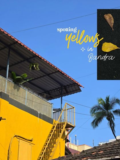 Spotting yellows in Bandra. A bright yellow staircase on the side of a building against a clear blue sky.