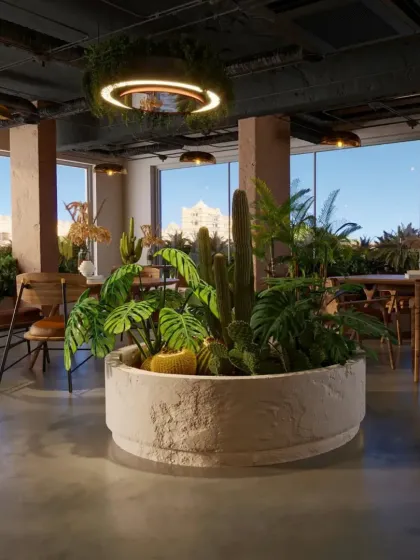 A central planter filled with cacti and tropical plants acts as a natural space divider. The large windows flood the cafe with natural light, enhancing the connection to the outdoors.