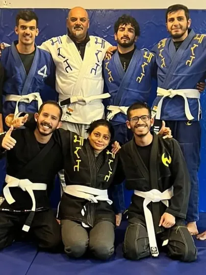 A group photo after a Gi class, with members of all belt levels from white to black.