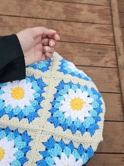 A close up shot of the finished Daisy Tote, showing how the granny squares are joined together to create the structure of the bag. The texture and pattern are what make it so unique.