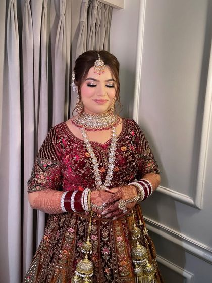 A moment of quiet elegance. Khushi's timeless bridal look, complete with a classic updo and perfectly placed jewelry, is the epitome of grace.