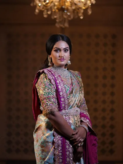 A regal portrait session for a client, featuring a stunning hand-embroidered blouse and a beautiful Kanjeevaram saree. The makeup was designed to give a royal, timeless feel.