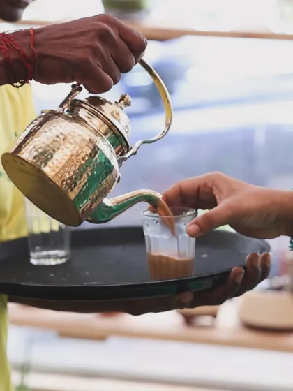 Nothing beats the comfort of a perfectly brewed cup of chai. Here you can see us pouring our special Kolkata-style tea from a traditional brass kettle. We serve it hot and fresh, making it a highlight for any get-together or party.
