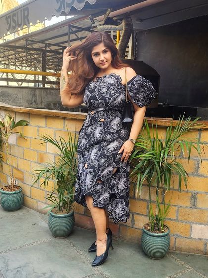 Another shot of the black floral dress, showing off its playful yet elegant silhouette.