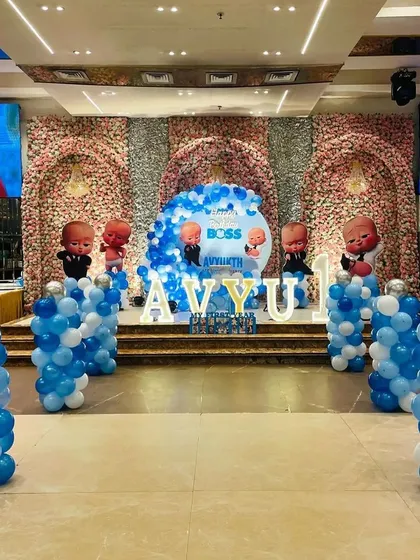 A wide shot of the Boss Baby party, showing how the themed balloon pillars filled the large hall space.