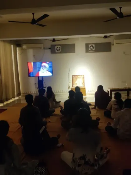 Watching a live broadcast from the Isha Yoga Center. These shared moments connect our small gathering to the larger, global Sangha.