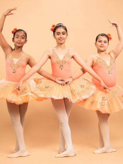 Dressed as blooming flowers, these dancers are ready for 'The Waltz of the Flowers' from The Nutcracker. Their poses capture the delicate beauty of nature's cycle, from bud to full bloom.