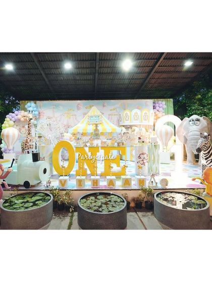 A wide shot of the pastel carnival setup, showing how we integrated large animal props like an elephant and zebra into the theme for a grander scale.