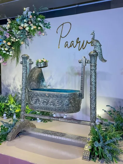 A closer look at the ornate silver cradle, a stunning centerpiece for a traditional naming ceremony.