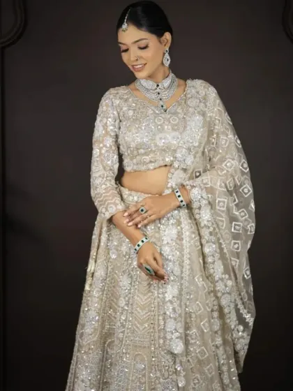 A graceful pose in the white and silver embroidered lehenga. This is a very popular rental for reception parties.
