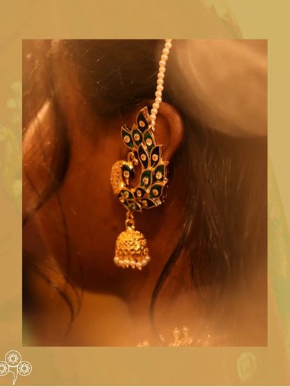 A close-up of the peacock earcuff, showing the beautiful enamel work.