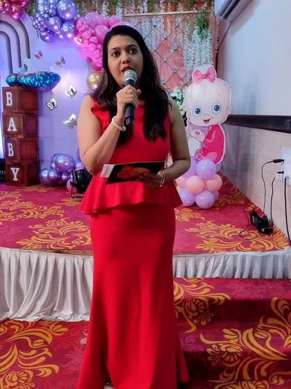 Here I am on stage, addressing the guests at a baby shower. Clear communication and a confident stage presence are key to keeping any event on track.