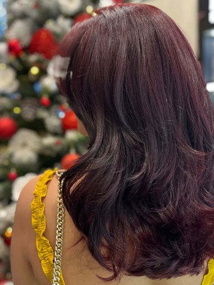 A side view of our Cherry Red Balayage, showing how the colour is layered to create depth and a vibrant, eye-catching style.