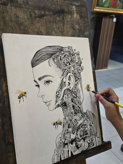 The artist adds a touch of color to the bees in her otherwise black and white micron pen drawing, creating a striking focal point.