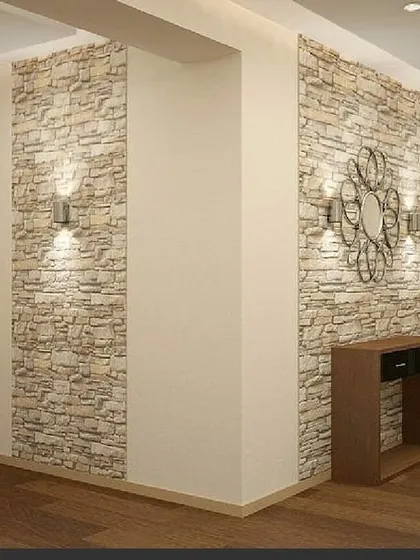 An example of a stone-clad accent wall in a hallway. This kind of textural feature adds depth and a rustic, earthy element to a modern interior.