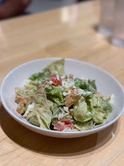 A fresh and healthy chicken salad, packed with greens, tomatoes, and protein. It's a great choice for a light lunch or a post-workout meal.