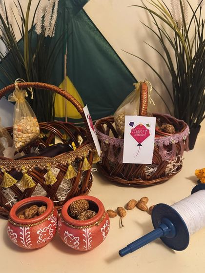 Our Sankranti collection, featuring decorated baskets and traditional matkas, all set against a backdrop of kites.
