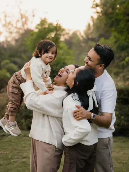 A joyful, candid moment as a family plays together outdoors. These unposed shots are often the most cherished memories from a family session.
