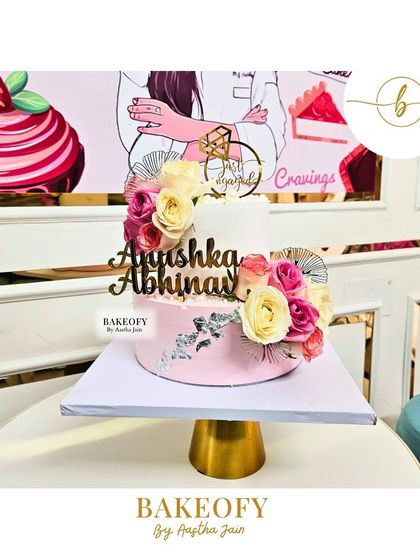 I made this 2.5 kg chocolate mousse cake for an engagement party. It features a two-tone pink and white design, decorated with elegant roses and a touch of silver for a sophisticated look.