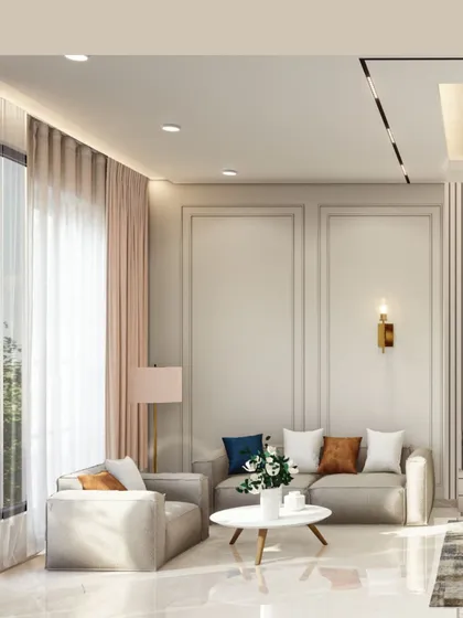 A closer look at the seating arrangement in a modern living room. The design focuses on clean lines, from the recessed ceiling light to the simple forms of the sofa and armchair, creating a minimalist yet inviting space.