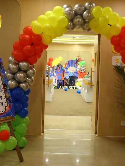 A welcoming balloon arch for a superhero-themed party, with colors representing different Avengers.