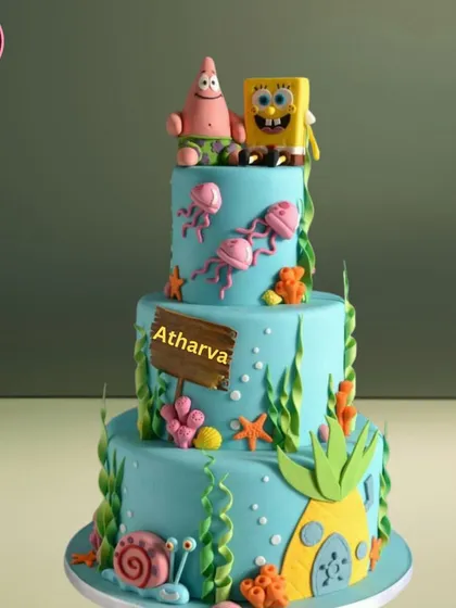 A three-tiered underwater adventure with this SpongeBob SquarePants theme cake. It features detailed, hand-crafted fondant figures of SpongeBob, Patrick, and their friends, making it a huge hit for kids' parties.