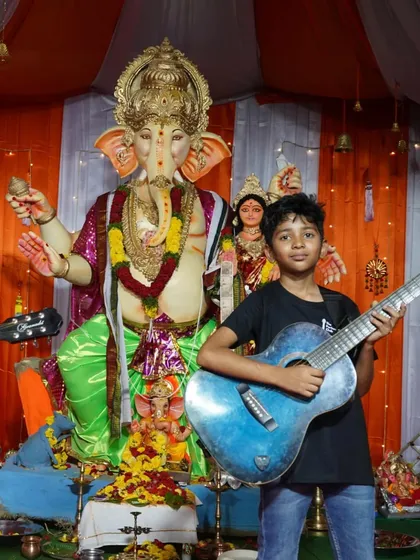 Two of our young rockstars posing with their guitars in front of the Ganesh idol. They put on a rocking show for the audience.