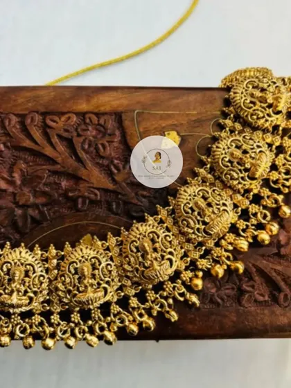A close-up of a temple jewellery kambarpatta, or waist belt. This piece is adorned with goddess motifs and is an essential part of a South Indian bridal look.