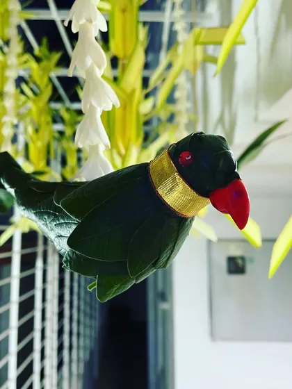 Attention to detail is key in my work. This handcrafted parrot, made from folded leaves with a delicate gold band, is an example of the small, traditional touches I incorporate to make your event decor truly special.