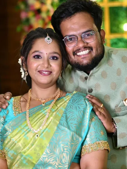 A happy couple during their engagement ceremony. The bride's makeup is fresh and radiant, matching the joyous occasion.
