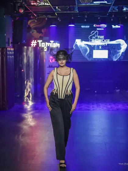A full-frontal runway shot from 'The Showcase Project', capturing the complete avant-garde look as the model walks towards the camera.