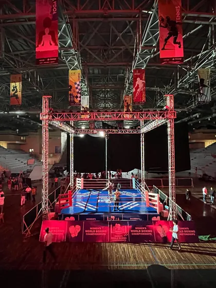 A full view of the boxing setup, showing the ring, lighting truss, and surrounding spectator area. This demonstrates our capacity to host international-level boxing events.
