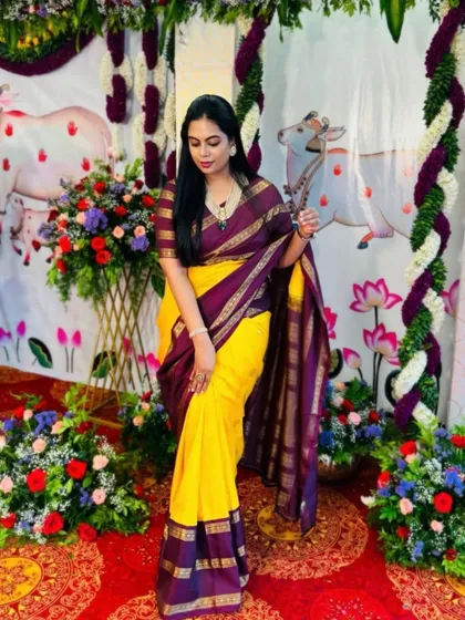 A full-length view of the client's vibrant yellow and purple saree, showing how the custom blouse completes the look.