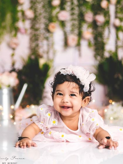 The reflection on the floor adds a beautiful, artistic element to this sitter session portrait, capturing this baby girl's infectious smile.