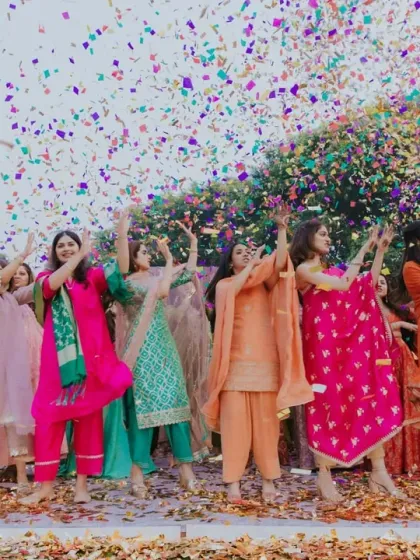 A colorful explosion of confetti celebrates the bride's tribe at the Mehendi. These moments are designed to be vibrant, photogenic, and full of collective joy.