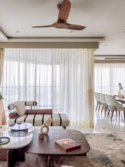 A bright, open-plan living and dining area from the 'Urban Tranquility' project. The space is filled with natural light, highlighting the clean lines and serene color palette.