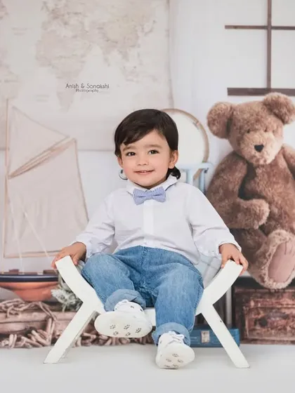 This little gentleman is ready to set sail. Our nautical traveler theme is filled with charming props like vintage suitcases, model ships, and world maps for an adventurous photoshoot.