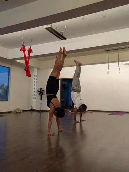 A quiet moment of focus during handstand practice in the studio. Progress is made in these moments of consistent effort.