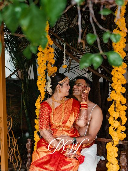 A candid moment of the couple on a swing at their South Indian wedding, a beautiful blend of tradition and destination charm.