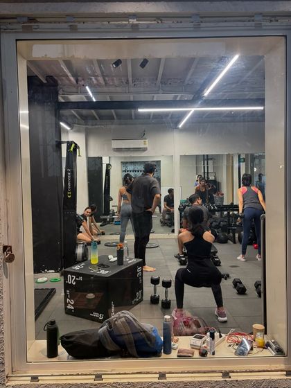 A view into our GROUNDED space during a busy session. Even with everyone working hard, the small group size ensures there's room to move and a trainer to guide you.