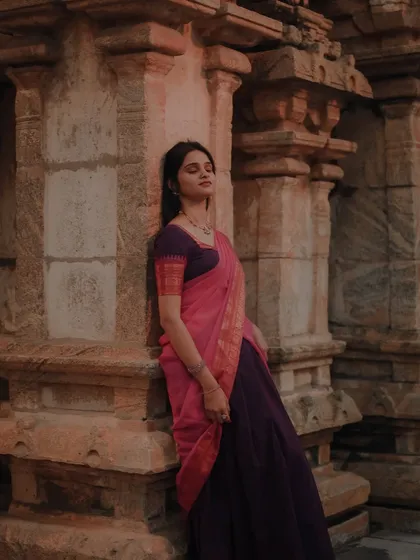 A moody, atmospheric portrait of a dancer at a temple. The soft light and her contemplative pose create a timeless and artistic image.